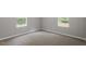 Neutral bedroom featuring carpet, trim and two windows with natural light at 141 S Creek Dr, Louisburg, NC 27549