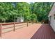 Exterior view of a spacious deck, perfect for outdoor relaxation and entertaining, with a serene backyard and wooded views at 141 S Creek Dr, Louisburg, NC 27549