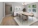 Elegant dining room with modern chandelier and views of the outdoors at 141 S Creek Dr, Louisburg, NC 27549