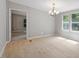 Dining room featuring a chandelier and natural light, with an adjacent doorway into a bedroom at 141 S Creek Dr, Louisburg, NC 27549