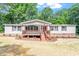 Charming single-story home boasts a welcoming front porch and well-maintained landscaping at 141 S Creek Dr, Louisburg, NC 27549