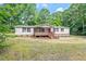 Charming single-story home with a welcoming front porch and landscaped yard, offering curb appeal and a cozy atmosphere at 141 S Creek Dr, Louisburg, NC 27549