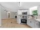 Modern kitchen features stainless steel appliances, white cabinets, and sleek countertops at 141 S Creek Dr, Louisburg, NC 27549