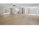 Open-concept floor plan with light wood floors and sliding door access to an outdoor deck at 141 S Creek Dr, Louisburg, NC 27549