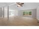 Open-concept floor plan with light wood floors and sliding door access to an outdoor deck at 141 S Creek Dr, Louisburg, NC 27549
