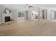 Bright living room with fireplace, deck access, and stylish light wood flooring throughout at 141 S Creek Dr, Louisburg, NC 27549