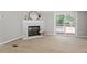 Cozy living room with a stone fireplace and sliding glass doors to the deck at 141 S Creek Dr, Louisburg, NC 27549