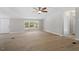 Spacious living area with a large window and views to a deck, light-colored walls and laminate flooring at 141 S Creek Dr, Louisburg, NC 27549