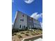 Back view of townhome, showcasing multiple windows and a tiered landscape at 1916 Fishamble St # 22, Fuquay Varina, NC 27526