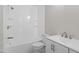 An all-white bathroom features a tub/shower, a toilet, and a single sink vanity with a large mirror at 1941 White Memorial Church Rd, Willow Springs, NC 27592