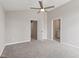 Spacious bedroom with neutral walls, soft carpeting, and open doorways to adjacent spaces at 1941 White Memorial Church Rd, Willow Springs, NC 27592