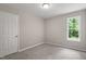 A cozy bedroom features neutral walls, soft carpeting, and a window overlooking the greenery outside at 1941 White Memorial Church Rd, Willow Springs, NC 27592