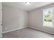 A cozy bedroom features neutral walls, soft carpeting, and a window overlooking the greenery outside at 1941 White Memorial Church Rd, Willow Springs, NC 27592