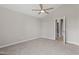 Spacious bedroom with neutral walls, soft carpeting, and open doorways to adjacent spaces at 1941 White Memorial Church Rd, Willow Springs, NC 27592