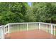 A view from the backyard deck shows the surrounding mature trees and a stained deck surface at 1941 White Memorial Church Rd, Willow Springs, NC 27592