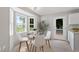 This eat-in dining area features a glass-topped table, comfortable seating, and bright natural light at 1941 White Memorial Church Rd, Willow Springs, NC 27592