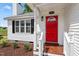 Charming home featuring a red front door, black shutters, and manicured landscaping at 1941 White Memorial Church Rd, Willow Springs, NC 27592