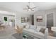 Bright living room with vaulted ceiling, modern fan, and neutral decor offers a comfortable and stylish space at 1941 White Memorial Church Rd, Willow Springs, NC 27592