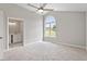 A spacious main bedroom features vaulted ceiling, ceiling fan, light gray walls and plush carpeting at 1941 White Memorial Church Rd, Willow Springs, NC 27592