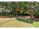 Backyard and golf course featuring mature trees and green fairways at 200 Greensview Dr, Cary, NC 27518