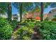 Brick two-story home with a spacious backyard, mature trees, and manicured landscaping at 200 Greensview Dr, Cary, NC 27518