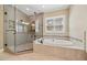 Luxurious bathroom featuring a glass shower and soaking tub at 200 Greensview Dr, Cary, NC 27518