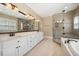 Bright bathroom featuring double vanity, granite countertops, and a glass-enclosed shower with decorative tile at 200 Greensview Dr, Cary, NC 27518