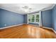 Comfortable bedroom with hardwood floors, a ceiling fan, and a bright window at 200 Greensview Dr, Cary, NC 27518