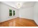 Bright bedroom with hardwood floors, a ceiling fan, and a beautiful window view at 200 Greensview Dr, Cary, NC 27518