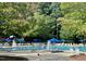 Community pool area with seating, umbrellas, and lounge chairs at 200 Greensview Dr, Cary, NC 27518