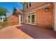 Wide brick home with wooden deck and view of a fenced yard at 200 Greensview Dr, Cary, NC 27518
