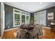 Cozy dining area with a hardwood floor, a large window, striped wallpaper, and a round wooden table at 200 Greensview Dr, Cary, NC 27518