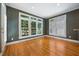 Dining area features hardwood flooring, plenty of windows, and an eye-catching striped wallpaper design at 200 Greensview Dr, Cary, NC 27518