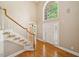 Two-story foyer features hardwood floors, a staircase, and a large arched window at 200 Greensview Dr, Cary, NC 27518