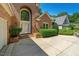 A beautiful view of the front door with a large arched window above and mature landscaping at 200 Greensview Dr, Cary, NC 27518