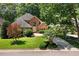 Charming brick home featuring mature trees, lush green lawn and a circular driveway at 200 Greensview Dr, Cary, NC 27518