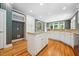 Spacious kitchen features an island, granite countertops, custom cabinetry, and hardwood floors at 200 Greensview Dr, Cary, NC 27518