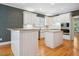 Bright kitchen with custom cabinets, hardwood floors, and an island with lots of counter space at 200 Greensview Dr, Cary, NC 27518