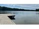 Wooden dock extending into a calm lake with trees in the background at 200 Greensview Dr, Cary, NC 27518