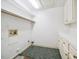 Functional laundry room with cabinets, shelving, and flooring at 200 Greensview Dr, Cary, NC 27518