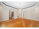 Open-concept living room features wood floors, crown molding, neutral paint, and plenty of natural light at 200 Greensview Dr, Cary, NC 27518
