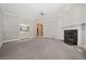 Large living room with neutral colors, fireplace, and built in storage at 200 Greensview Dr, Cary, NC 27518