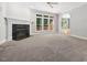 Open living room with fireplace and views of the backyard at 200 Greensview Dr, Cary, NC 27518