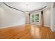 Open-concept living room features wood floors, crown molding, neutral paint, and plenty of natural light at 200 Greensview Dr, Cary, NC 27518