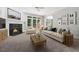 Bright living room with fireplace, neutral furniture, and large windows at 200 Greensview Dr, Cary, NC 27518