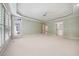 Large primary bedroom with tray ceilings, carpet, and backyard access at 200 Greensview Dr, Cary, NC 27518