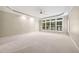 Expansive primary bedroom with tray ceiling, carpet, and large windows at 200 Greensview Dr, Cary, NC 27518