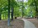 Paved path leading to a playground in a wooded area at 200 Greensview Dr, Cary, NC 27518