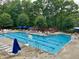 Outdoor swimming pool with lounge chairs and tables at 200 Greensview Dr, Cary, NC 27518
