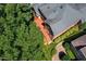 Aerial shot of the rear yard with deck, landscaping, and trees at 200 Greensview Dr, Cary, NC 27518